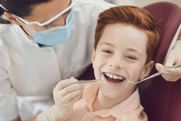 Young boy being examined by dentist 