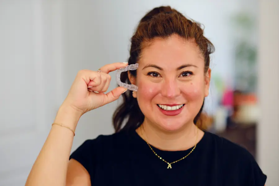 Woman Holding Clear Aligners